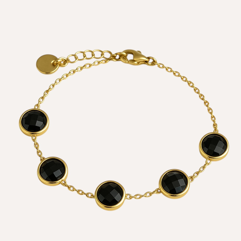 Bracelet Exact doré à pierres rondes noires serties, sur fond blanc - Ordiajade