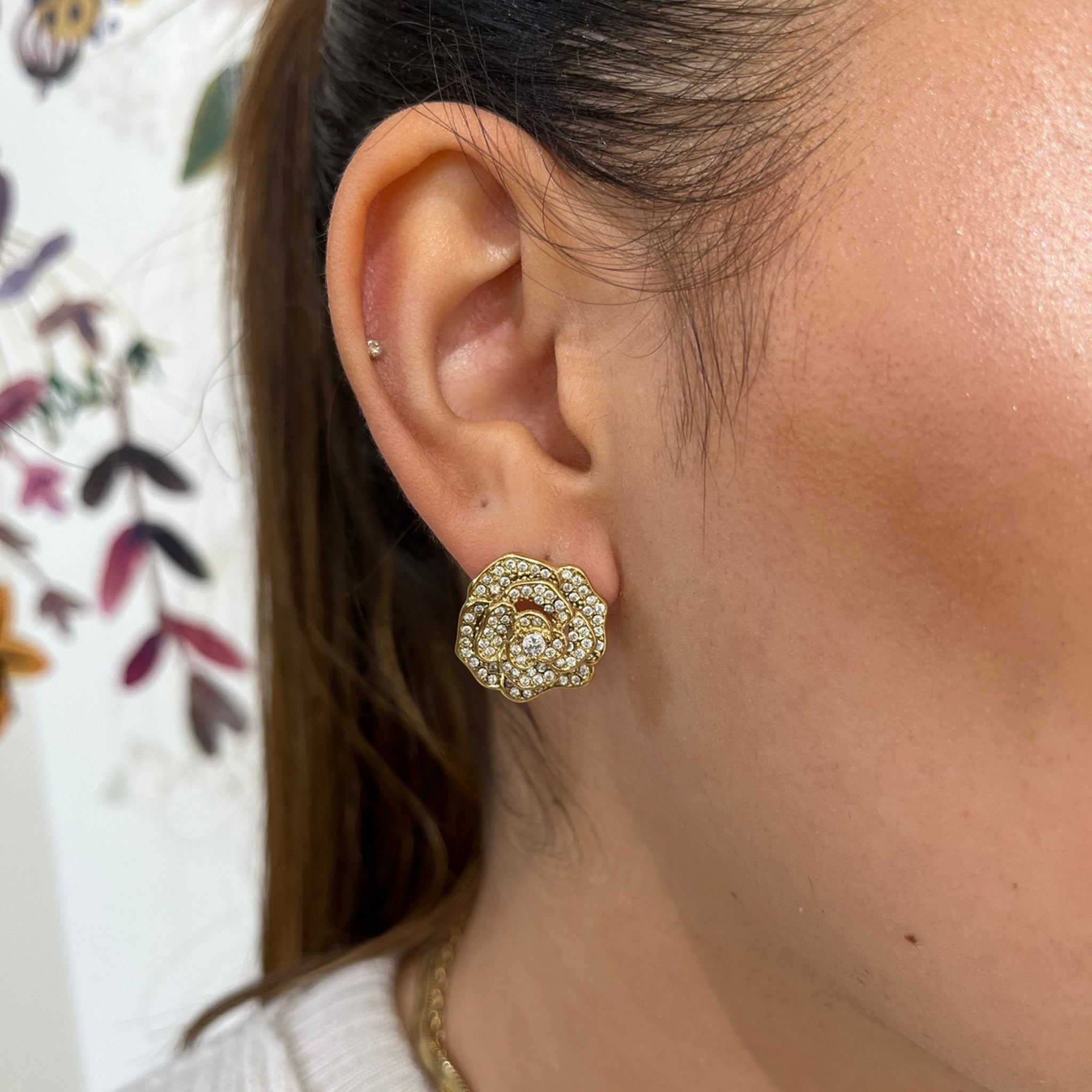 Boucles Rosie dorées en forme de fleur pavée de strass, portées à l'oreille - Ordiajade
