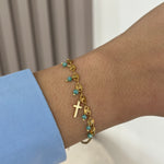Bracelet Croix Ocean doré en acier inoxydable avec pampilles perles turquoises porté au poignet - Ordiajade