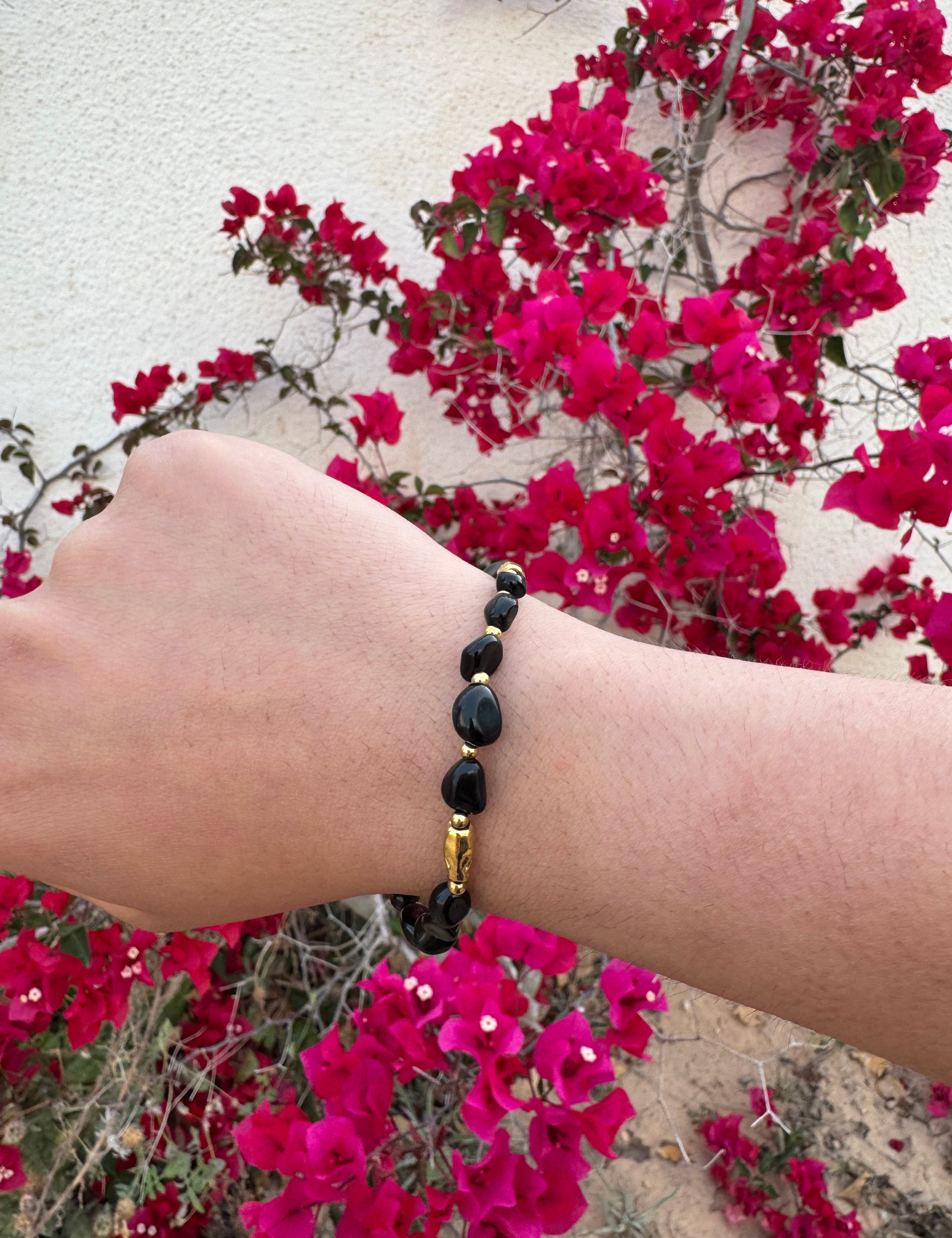 Bracelet doré en acier inoxydable avec véritables pierres noires porté au poignet - Bijoux Ordiajade