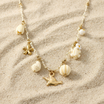 Collier doré oiseau et tortue en acier inoxydable sur fond sable - Ordiajade