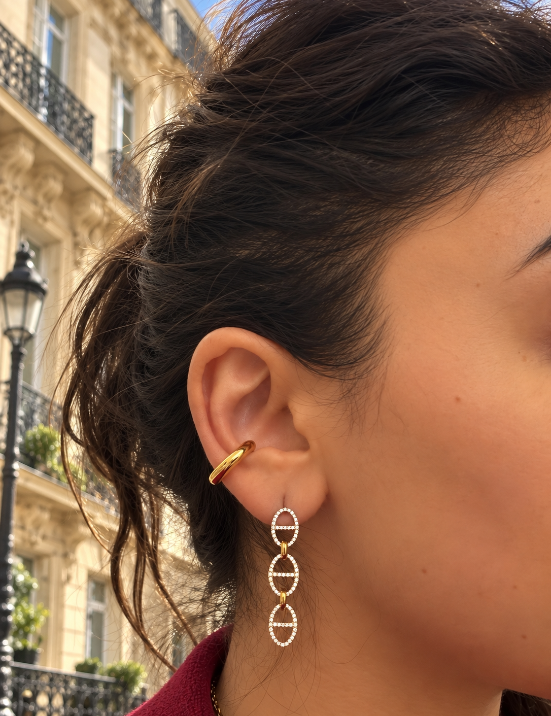 Ear cuff Grenelle doré lisse en acier inoxydable porté à l'oreille dans une rue parisienne - Ordiajade