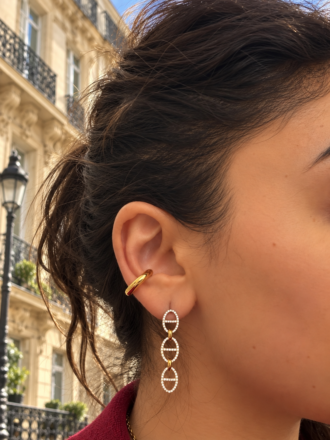 Ear cuff Grenelle doré lisse en acier inoxydable porté à l'oreille dans une rue parisienne - Ordiajade